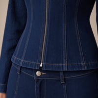 Détail du zip, des découpes surpiquées et du grain du denim bleu foncé – SAKIWÉ