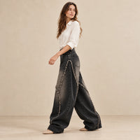 Jean baggy noir-gris vintage à coutures courbes effilochées, vue de profil