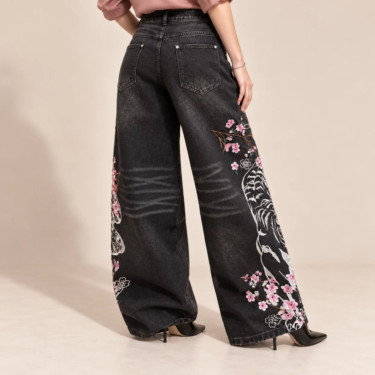 Détail du motif blanc et rose au dos des jambes du jean large