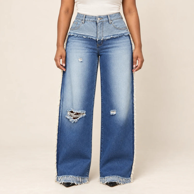Détail du jean bleu : taille rabattue, franges et déchirures