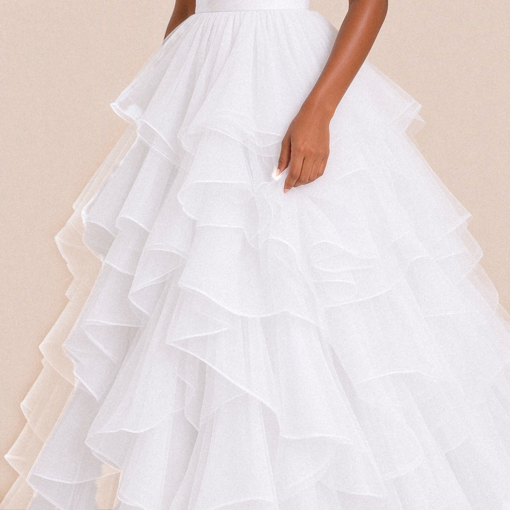 Gros plan sur les volants de tulle superposés de la robe de bal blanche