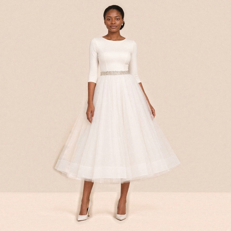 Femme portant la robe de mariée mi-longue à manches 3/4 et jupe en tulle, vue de face