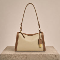 Sac porté épaule oreiller en cuir grainé à zip et pampille dorée