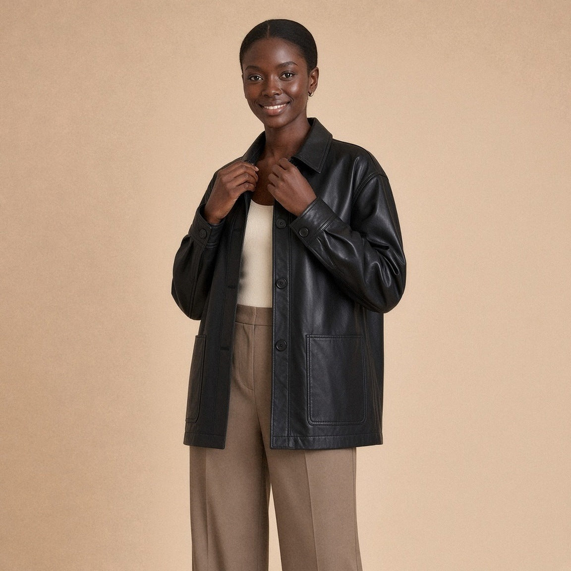 Surchemise oversize en cuir de mouton noir SAKIWE portée, mains au col chemise